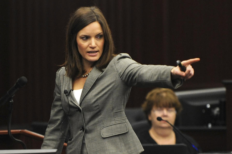 Assistant State Attorney Erin Wolfson points at the defendant Michael Dunn during the State's closing arguments in Dunn's trial, Wednesday, Feb. 12, 2014 in Jacksonville, Fla. Dunn is charged with fatally shooting 17-year-old Jordan Davis after an argument over loud music outside a Jacksonville convenient store in 2012.(AP Photo/The Florida Times-Union, Bob Mack, Pool)