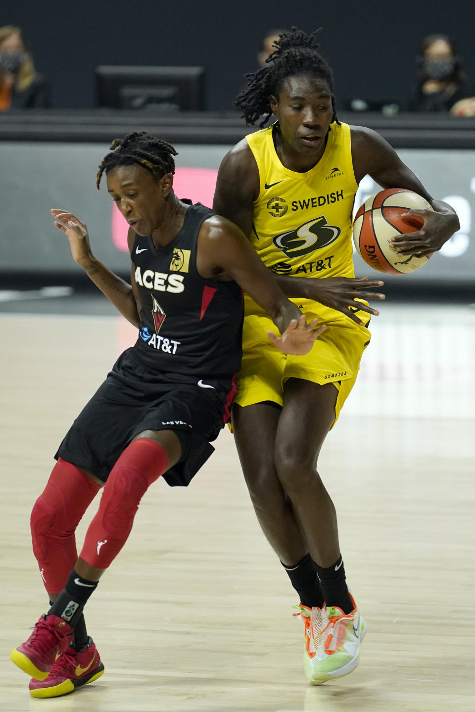 Seattle Storm forward Natasha Howard (6) and Las Vegas Aces guard Danielle Robinson (3) collide chaseing a loose ball during the first half of Game 1 of basketball's WNBA Finals Friday, Oct. 2, 2020, in Bradenton, Fla. (AP Photo/Chris O'Meara)