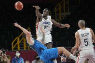 France's Moustapha Fall (93) blocks Slovenia's Luka Doncic (77) during a men's basketball semifinal round game at the 2020 Summer Olympics, Thursday, Aug. 5, 2021, in Saitama, Japan. (AP Photo/Eric Gay)