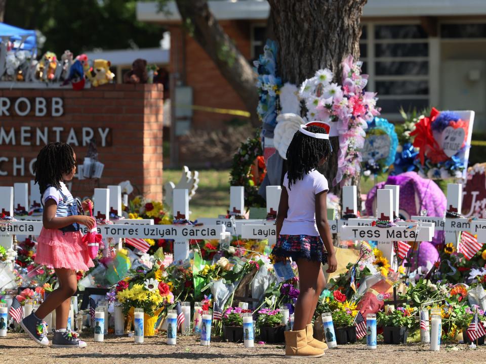 Young girls pay respect at a memorial for Uvalde shooting