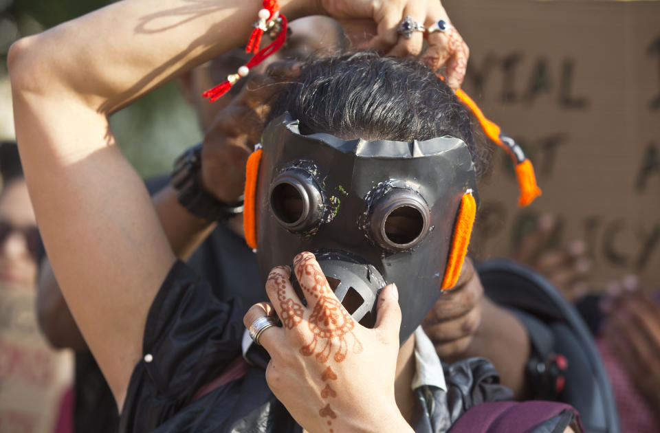 A protester wears a gas mask and marches on a street in Gauhati, India, Friday, Sept. 20, 2019. The protestors gathered in response to a day of worldwide demonstrations calling for action to guard against climate change began ahead a U.N. summit in New York. (AP Photo/Anupam Nath)