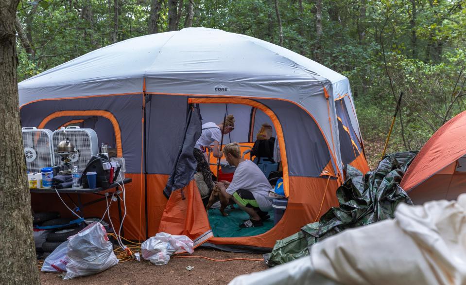 The Jamisons cleaned around the tent while Frances Jamison spent a few days in the hospital with breathing issues. A homeless camp in the woods in Toms River on August 10, 2023