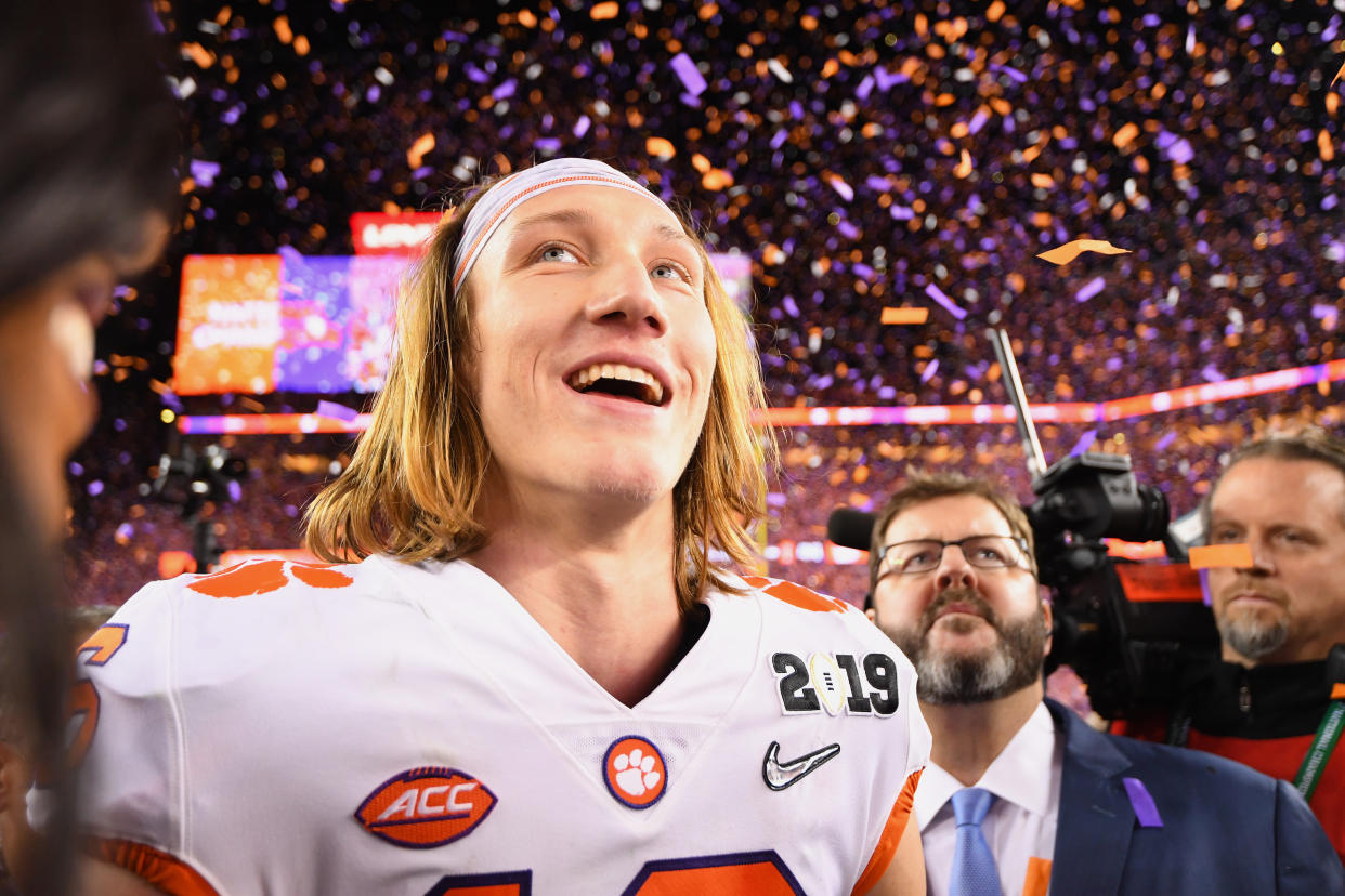 Quarterback Trevor Lawrence celebrates after his Clemson Tigers defeated the Alabama Crimson Tide for college football's national championship on Jan. 7. He and his teammates aren't paid for their efforts. (Photo: Jamie Schwaberow/Getty Images)