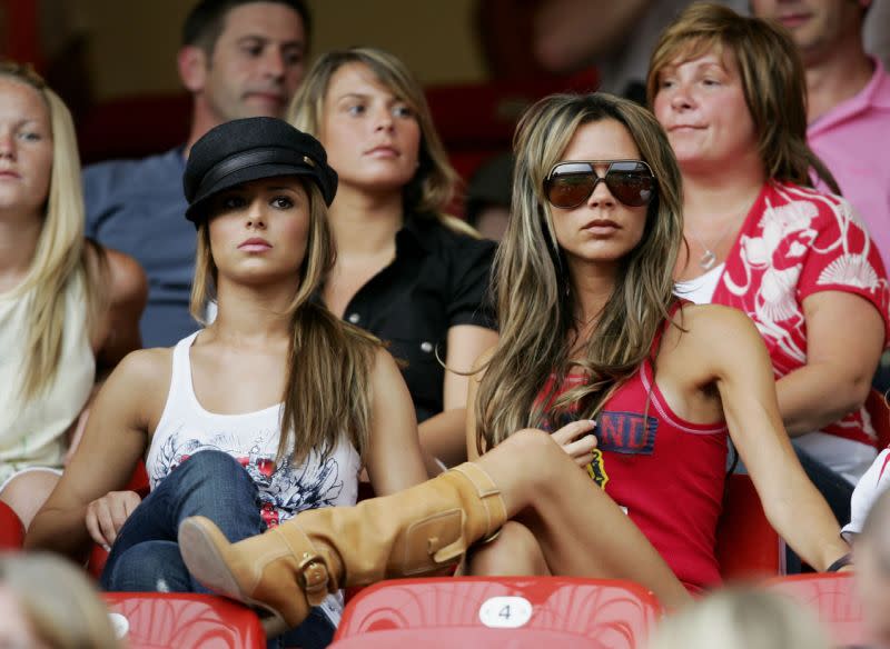 Cheryl (then) Tweedy and Victoria Beckham watching a match at the 2006 World Cup. [Photo: Getty]