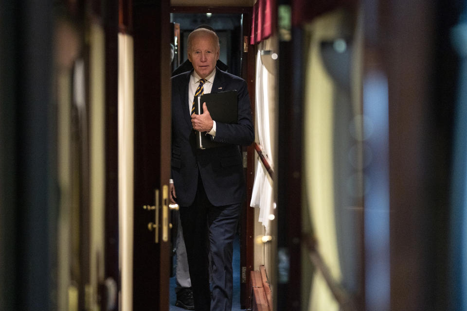 President Joe Biden walks down a corridor to his cabin on a train after a surprise visit with Ukrainian President Volodymyr Zelenskyy, Monday, Feb. 20, 2023, in Kyiv. Biden took a nearly 10-hour train ride from Poland into Kyiv. (AP Photo/Evan Vucci)