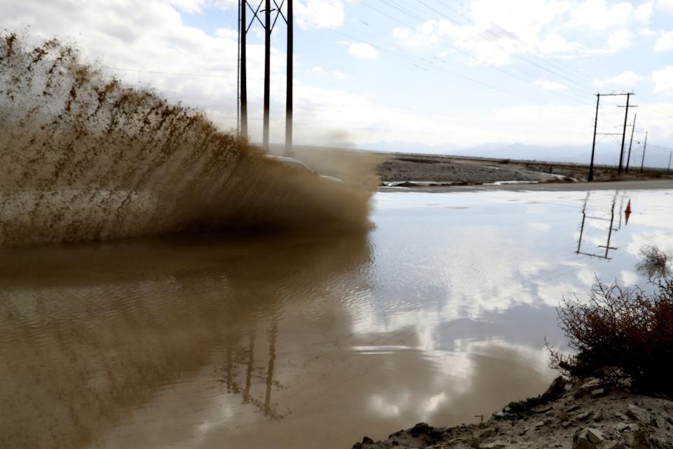 Motorist navigate the flooded southbound lane on Indian Canyon Drive in Palm Springs, Calif., on Sunday morning, February 4, 2024. Forecast predict rainfall for the coming days.