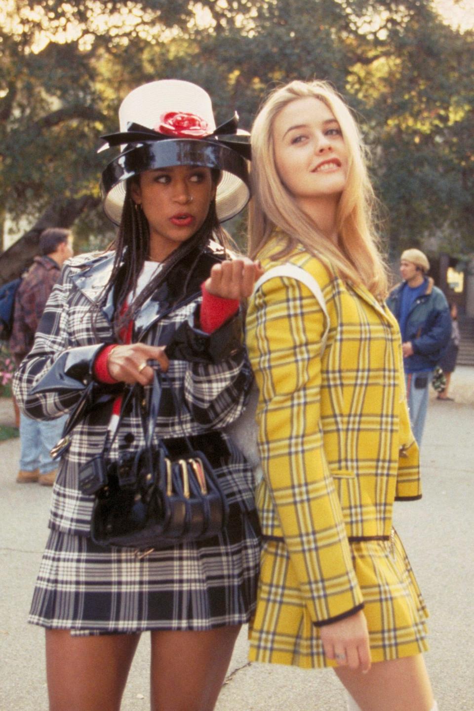 Two women in stylish plaid outfits from the film 'Clueless'