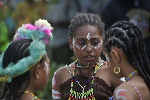 Papuan children at the Lake Sentani festival in the Jayapura district of the Indonesian eastern province of Papua. Some 80 percent of New Guinea's people live in rural areas and many tribes, especially in the isolated mountains, have little contact with one another, let alone with the outside world