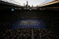 The sun sets as Novak Djokovic of Serbia and Stan Wawrinka of Switzerland play during their men's singles semi-final match at the Australian Open 2015 tennis tournament in Melbourne January 30, 2015. REUTERS/Carlos Barria (AUSTRALIA - Tags: SPORT TENNIS)