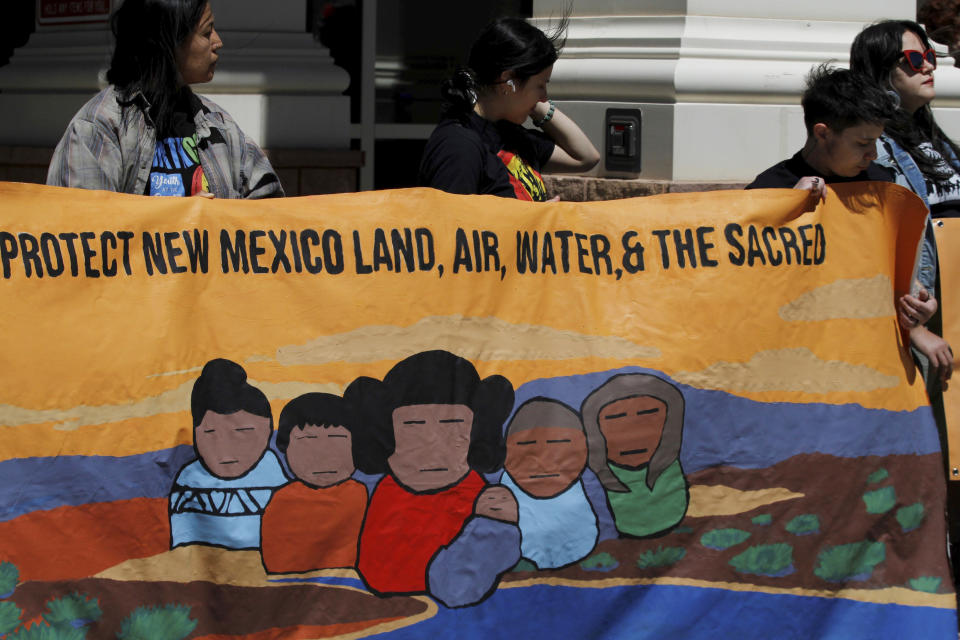 Protesters highlight complaints about pollution from oil and natural gas development and frustration with state oversight of the industry outside the state First District Court in Santa Fe, N.M., on Wednesday, May 10, 2023. The nation's No. 2 oil-producing state is being sued on allegations that it failed to meet constitutional provisions meant to protect against pollution from the energy industry. (AP Photo/Morgan Lee)