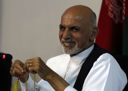 Afghan presidential candidate Ashraf Ghani Ahmadzai smiles during a news conference in Kabul June 26, 2014. REUTERS/Omar Sobhani