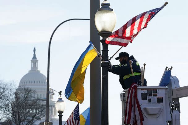 PHOTO: A worker installs Ukrainian and U.S. flags near the U.S. Capitol ahead of a visit by Ukraine's President Volodymyr Zelenskyy for talks with President Joe Biden and an address to a joint meeting of Congress, Dec. 21, 2022, in Washington. (Kevin Lamarque/Reuters)