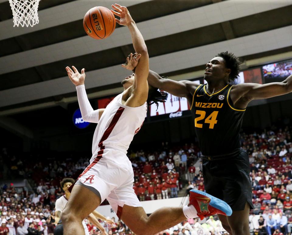 Missouri forward Kobe Brown (24) hammers Alabama guard Jaden Shackelford (5) as he goes to the hoop but no foul was called in Coleman Coliseum Saturday, Jan. 22, 2022. Alabama came from behind to defeat Missouri 86-76. 