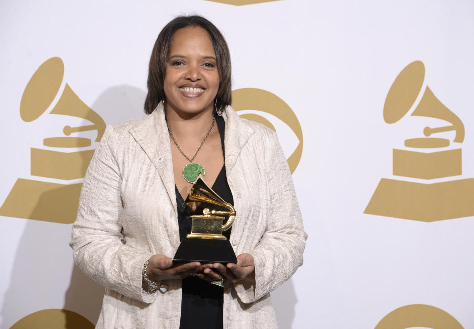 FILE - Terri Lyne Carrington poses in the press room with the award for best jazz instrumental album for "Money Jungle: Provocative In Blue" press room at the 56th annual Grammy Awards Jan. 26, 2014, in Los Angeles. The three-time Grammy winner is nominated for best instrumental jazz album – an award she won in 2014 and is the only woman to do so in the show’s 63-year history. (Photo by Dan Steinberg/Invision/AP, File)