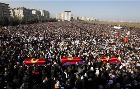 Thousands of people are seen attending the funeral ceremony of the three Kurdish activists shot in Paris, in Diyarbakir, the largest city in Turkey's mainly Kurdish southeast, January 17, 2013. REUTERS/Umit Bektas