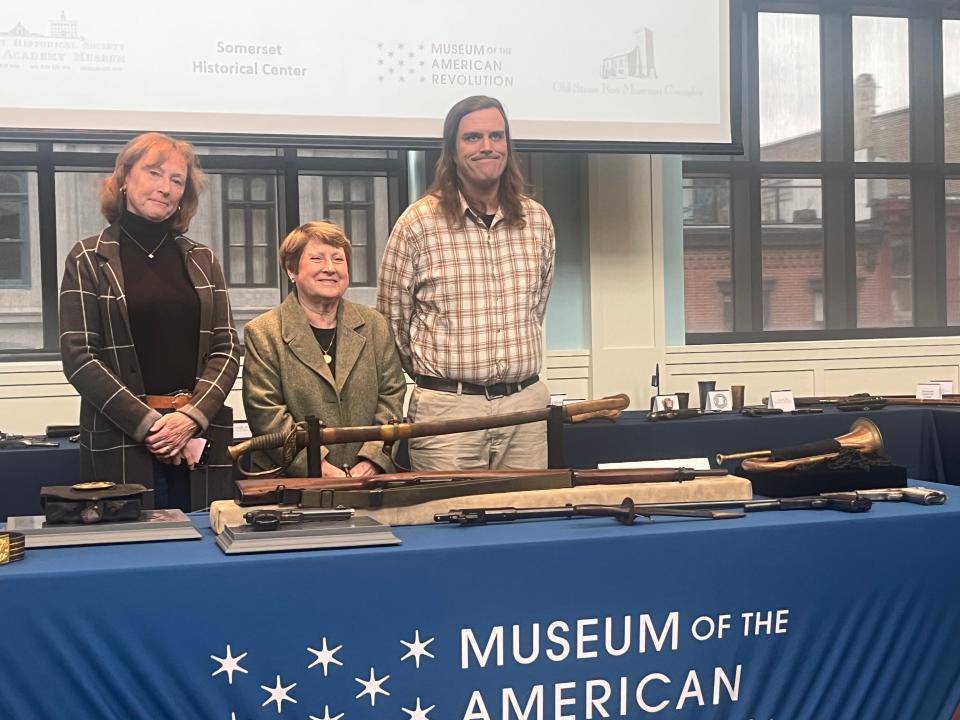 Delaware County Historical Society staff stand with items repatriated to their museum on March 13, 2023. Items include an officer's sword form the 1850s, a Civil War bugle, and multiple historic firearms from the 19th and early 20th centureis.