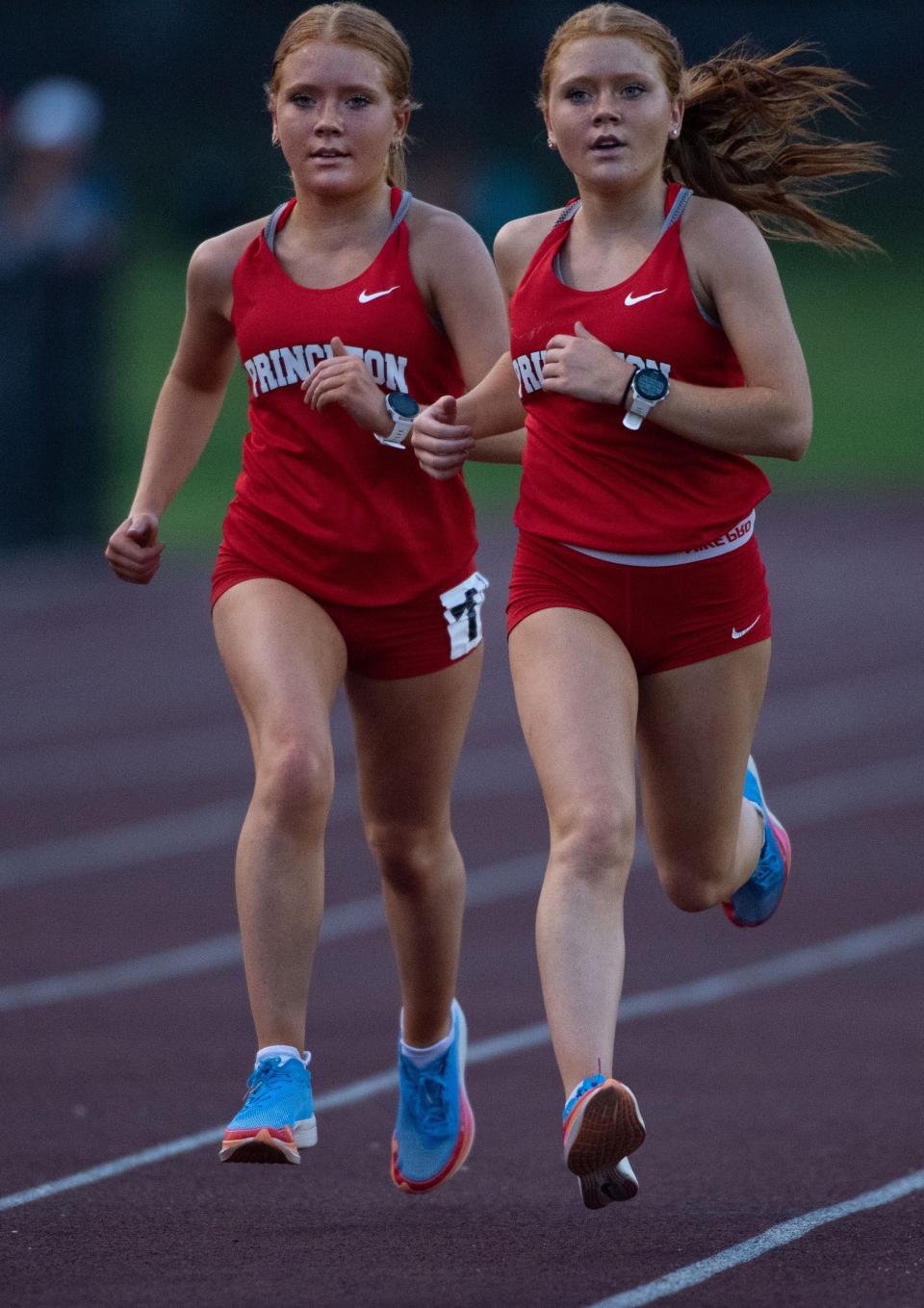 Princeton's Haley Meade, left, and Heidi Meade lead the competitors in the 3200 meter run during the IHSAA Girls Regional 8 Track & Field Meet at Central Stadium Tuesday evening, May 23, 2023. The sisters finished in first and second place respectively with times of 11:09.97 and 11:10.09.