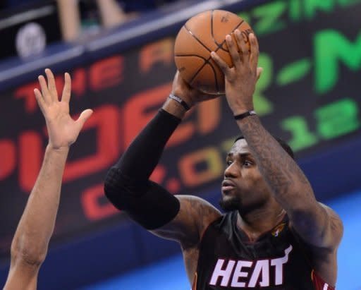 LeBron James (R) of the Miami Heat shoots against Thabo Sefolosha of the Oklahoma City Thunder during Game 2 of the NBA Finals at the Chesapeake Energy Arena in Oklahoma City, Oklahoma, on June 14. The Heat beat Oklahoma City 100-96 to level the finals at one game apiece