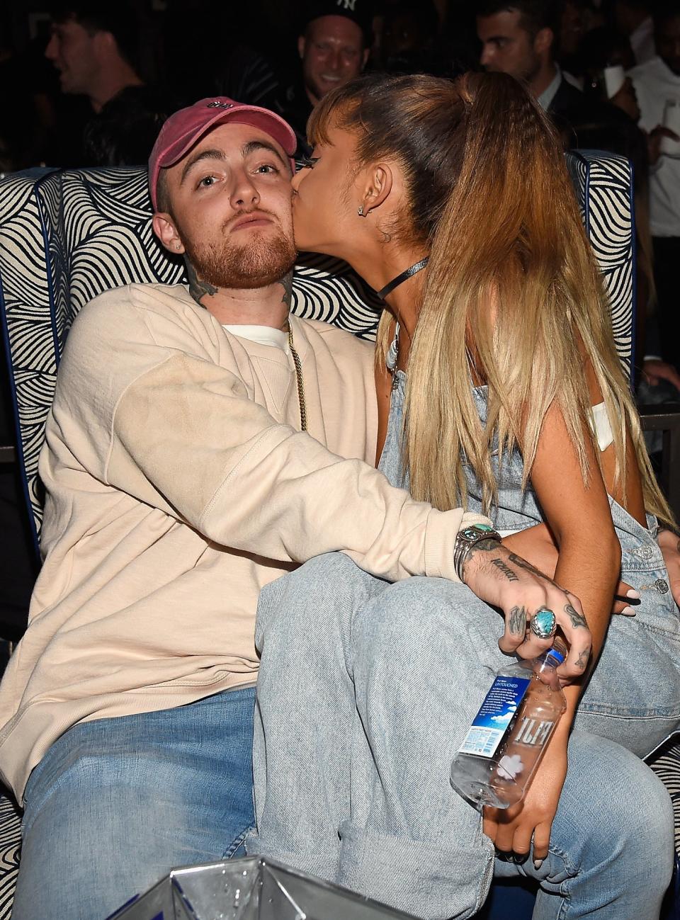 Closeup of Mac and Ariana with the singer sitting on Mac's lap