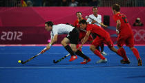 LONDON, ENGLAND - JULY 30: Christopher Wesley of Germany is challenged by Simon Gougnard of Belgium during the Men's Hockey Match between Belgium and Germany on Day 3 of the London 2012 Olympic Games at the Riverbank Arena on July 30, 2012 in London, England. (Photo by Daniel Berehulak/Getty Images)