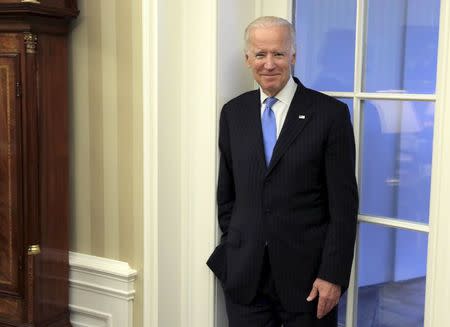 U.S. Vice President Joe Biden watches as U.S. President Barack Obama and Colombia's President Juan Manuel Santos speak during a bilateral meeting in the Oval Office of the White House in Washington February 4, 2016. REUTERS/Joshua Roberts