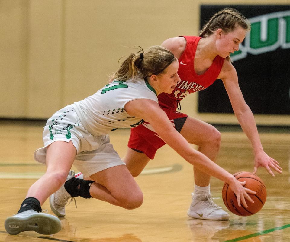 Eureka's Ellie Cahill, left, battles for the ball during a 2019 girls basketball game against Brimfield.