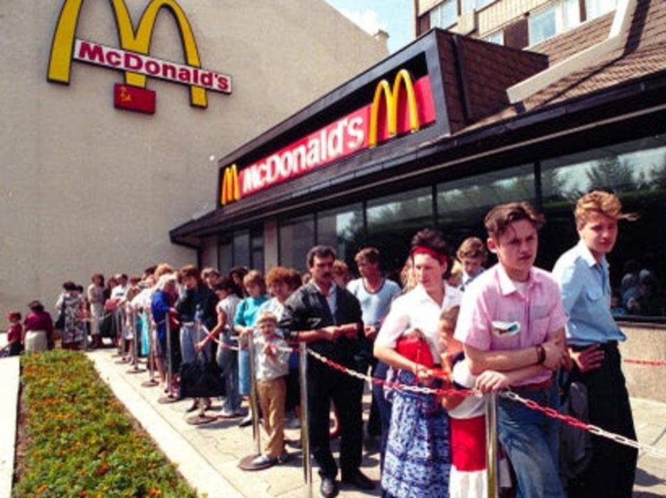 Moscow residents wait outside Russia’s first McDonald’s in 1991 (AP)