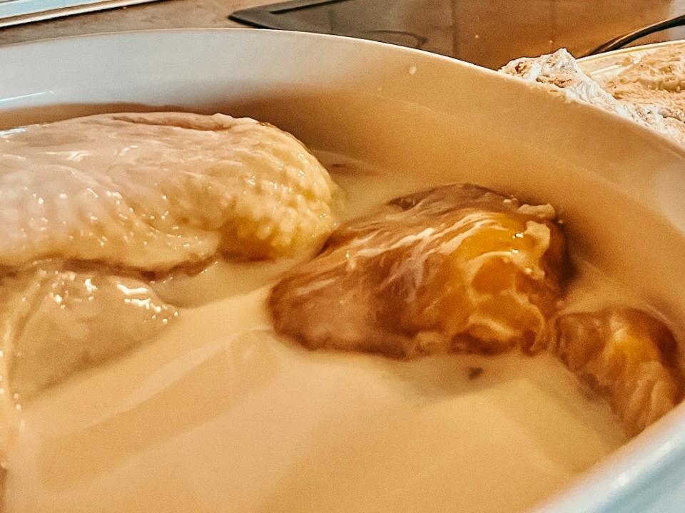 raw chicken sitting in a bowl of buttermilk