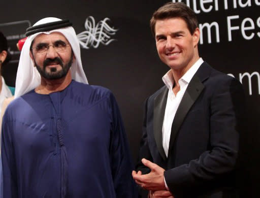 UNITED ARAB EMIRATES, Dubai : US actor Tom Cruise (R) poses on the red carpet with Emirati Prime Minister and Dubai ruler Sheikh Mohammed bin Rashed al-Maktoum upon their arrival to the opening ceremony of the Dubai International Film Festival (DIFF) in the Gulf emirate on December 7, 2011. AFP PHOTO / MARWAN NAAMANI