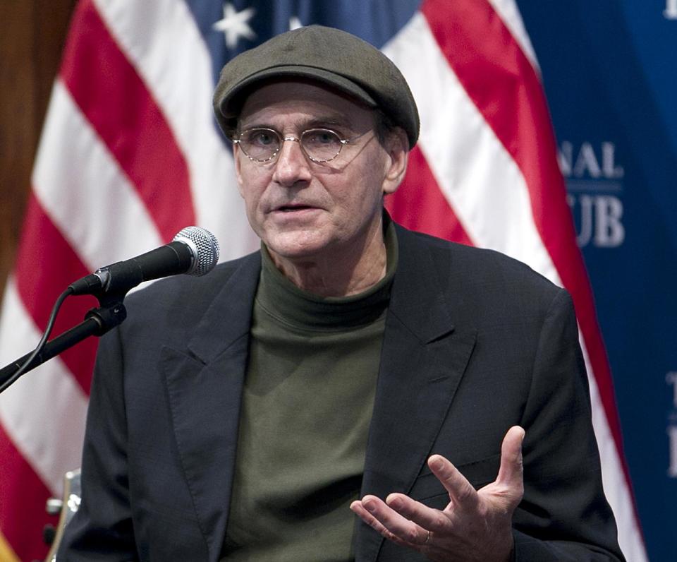 FILE - This Dec. 7, 2012 file photo shows Grammy Award-winning singer-songwriter James Taylor speaking at National Press Club in Washington. The inaugural committee planning the Jan. 21 event announced Wednesday that Taylor will sing "America the Beautiful" at the swearing-in ceremony on the Capitol's west front and Kelly Clarkson will perform "My Country `Tis of Thee" . Beyonce will sing the national anthem at President Barack Obama's inauguration ceremony. (AP Photo/Jose Luis Magana, File)