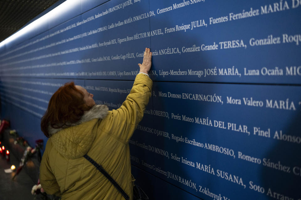 A woman points to the name of a train bombing victim at a memorial inside Atocha train station in Madrid, Spain, Monday, March 11, 2024. Victims of terror attacks are a symbol of the constant need to guard freedom and the rule of law against threats, Spain’s King Felipe VI said Monday at a ceremony marking the 20th anniversary of Europe’s deadliest terror attack. March 11 was chosen as a day of continent-wide commemoration of terrorism victims after the train bombing in the Spanish capital on March 11, 2004 that killed nearly 200 people. (AP Photo/Bernat Armangue)