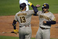 San Diego Padres' Trent Grisham, right, celebrates his solo home run with Manny Machado (13) during the sixth inning of the team's baseball game against the Los Angeles Dodgers on Thursday, April 22, 2021, in Los Angeles. (AP Photo/Marcio Jose Sanchez)