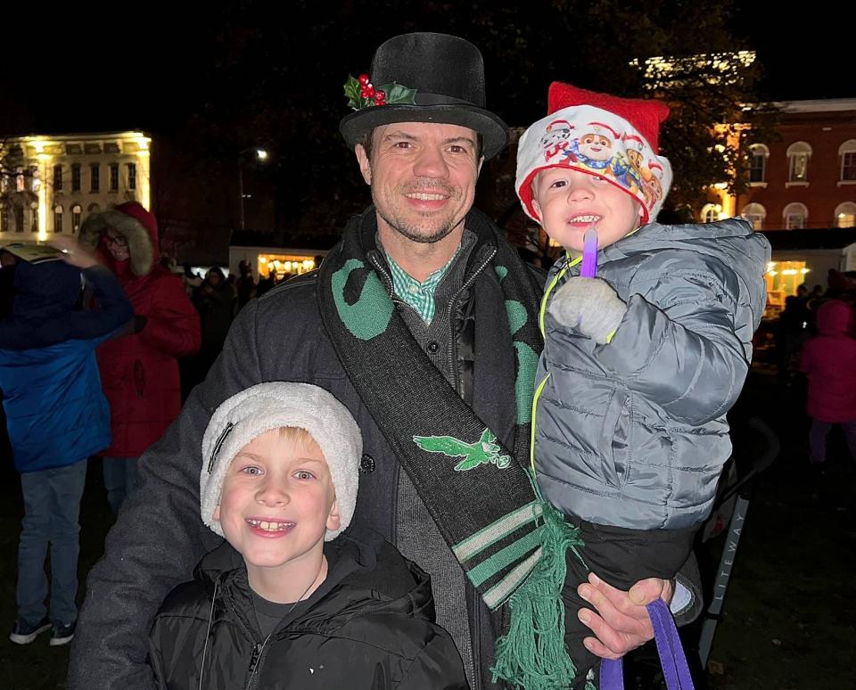 Keith Montigny, of Erie, with his sons Jack, 7, left, and Henry, 3, during their first Downtown D'Lights on Friday.