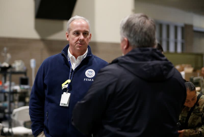 FEMA representatives talk at a military field hospital for non-coronavirus patients inside CenturyLink Field Event Center during the coronavirus disease (COVID-19) outbreak in Seattle