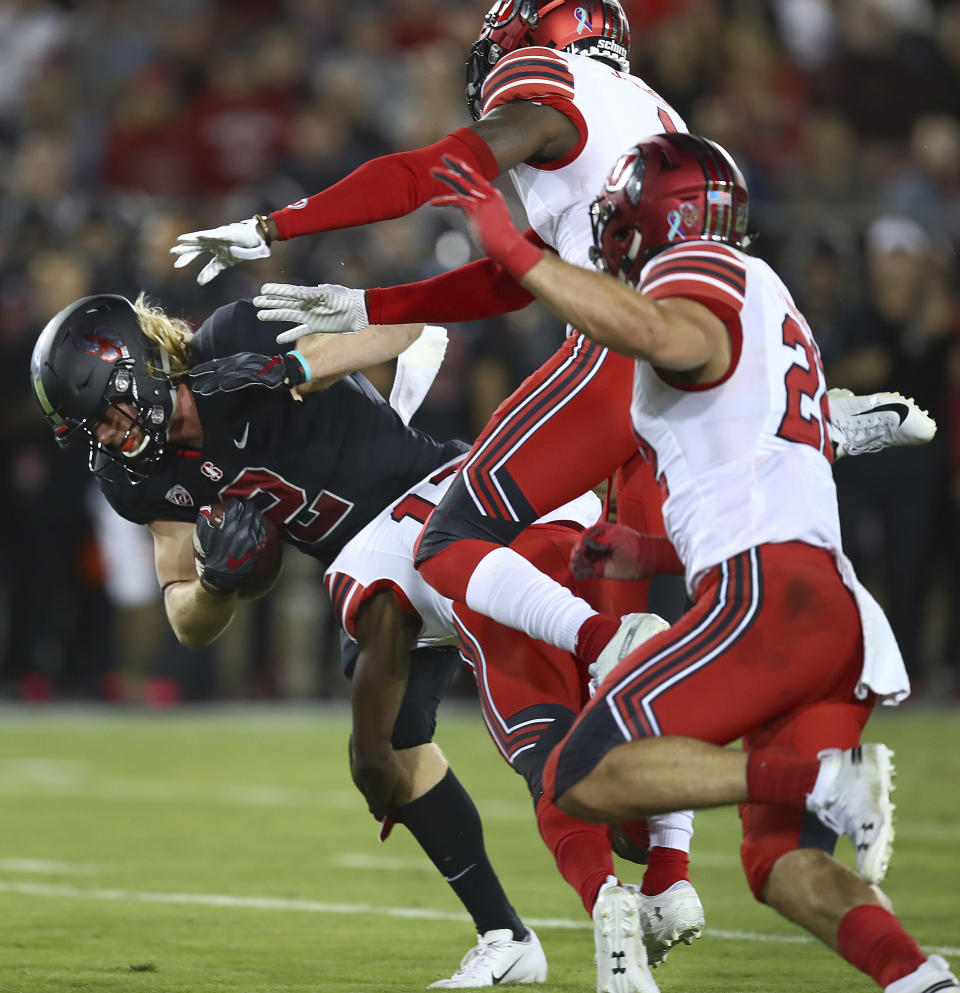 Stanford's Trenton Irwin, left, runs against Utah's Chase Hansen (22) and another defender during the first half of an NCAA college football game Saturday, Oct. 6, 2018, in Stanford, Calif. (AP Photo/Ben Margot)