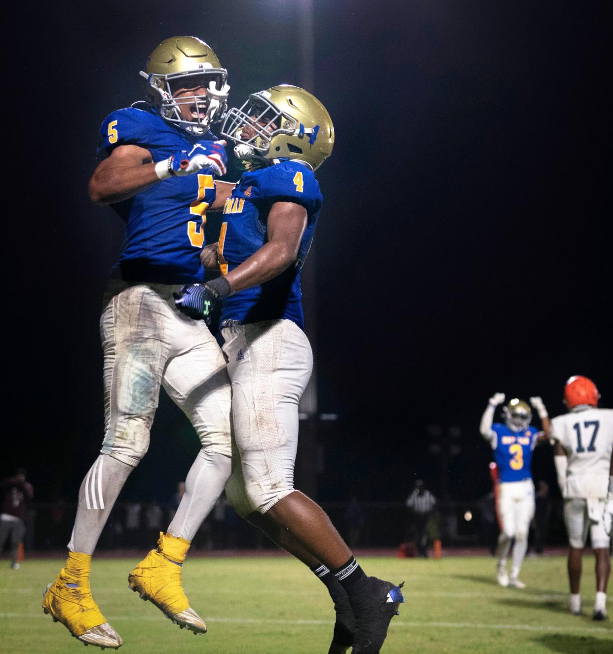 Cardinal Newman wide receiver Max Redmon, left, celebrates his touchdown with running back Jaylin Brown against Benjamin during their football game on October 20, 2023 in West Palm Beach, Florida.