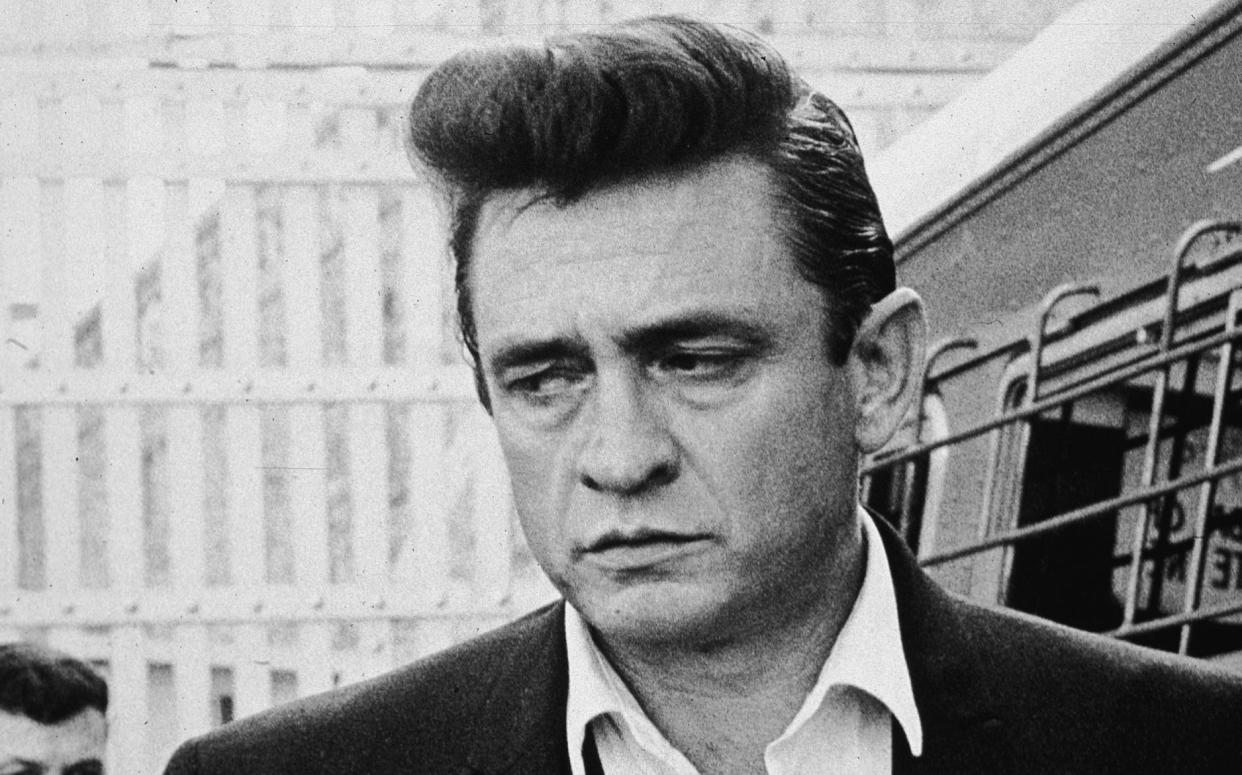 Johnny Cash inside Folsom prison, California, preparing for his fourth concert for inmates in 1964 - HULTON ARCHIVE