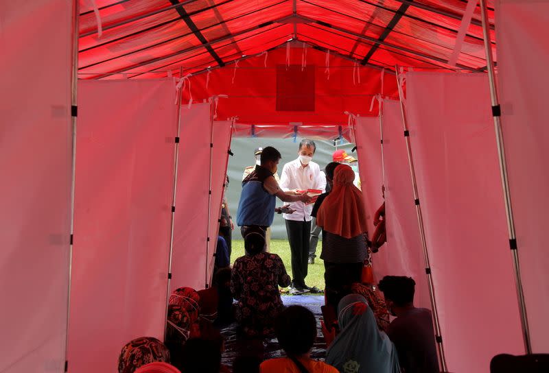 Indonesian President Joko Widodo visits temporary shelters for displaced people affected by the earthquake in Mamuju