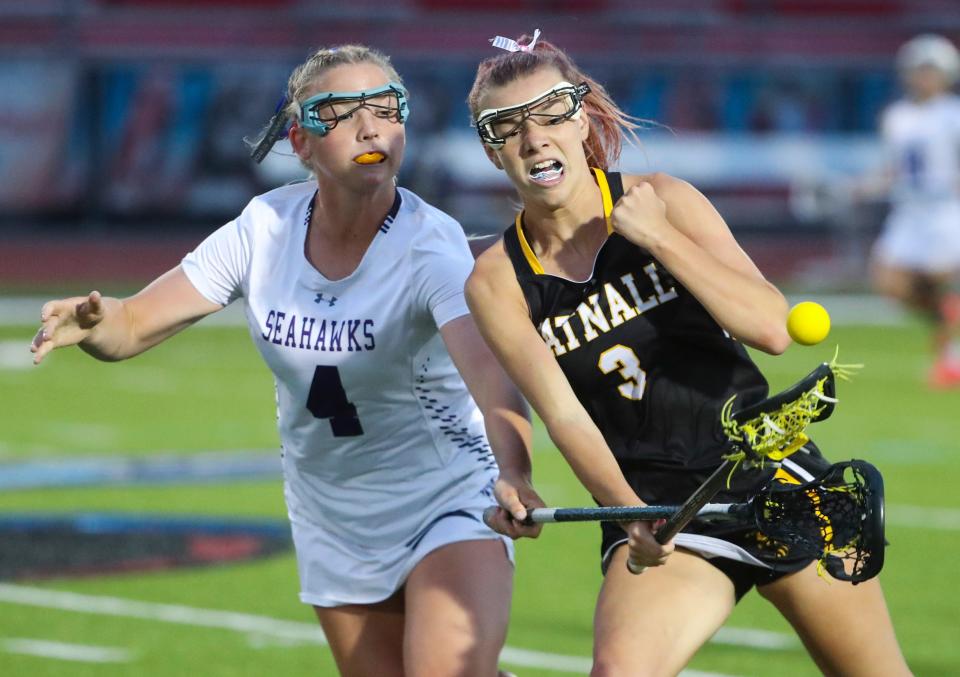 Sussex Academy's Sanne Elling (left) and Tatnall's Kali Clayton fight for the ball near midfield.