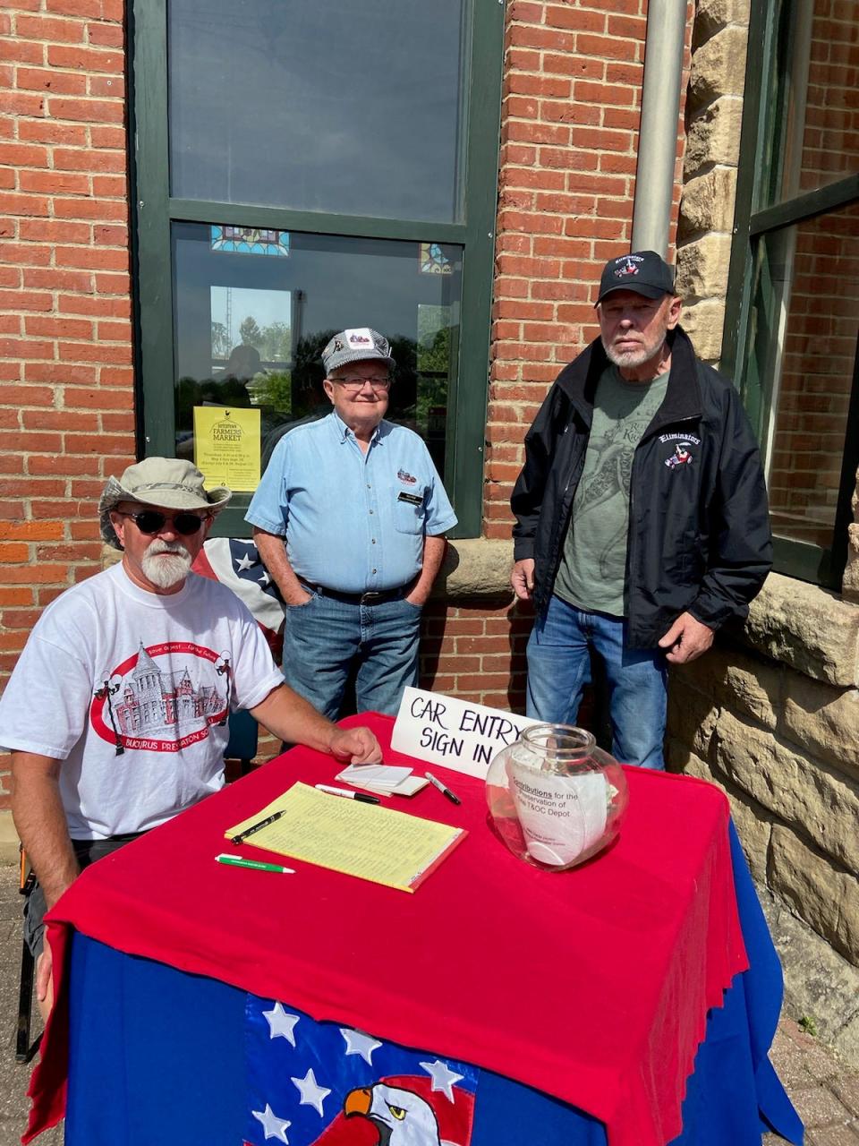 John Cauvel, left, and Rob Streib of the Bucyrus Preservation Society and Bob Ellis from Olivesburg, a member of the Eliminators Car Club, are ready to sign in vehicles arriving at Saturday’s show at the depot.