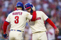 Philadelphia Phillies' Bryce Harper, left, celebrates his two-run home run with Rhys Hoskins, right, during the sixth inning of a baseball game against the Atlanta Braves, Saturday, Sept. 24, 2022, in Philadelphia. The Braves won 6-3. (AP Photo/Chris Szagola)