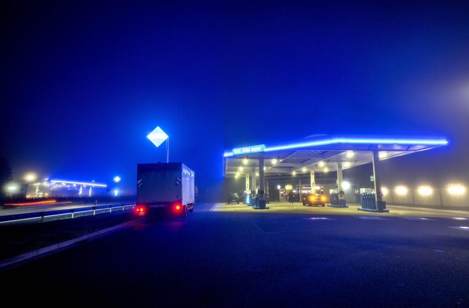 FILE - A truck parks at a gas station in Frankfurt, Germany, early Thursday, Oct. 13, 2022. Drivers in the U.S. and Europe are getting a break from the record-high pump prices they endured over the summer. But that price tag is still difficult for many customers who have been enduring relentless inflation and were used to lower prices. (AP Photo/Michael Probst, File)