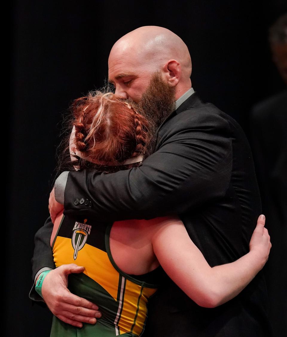 Northeastern Heather Crull hugs Todd Crull, her father and coach, after losing the 106-pound weight class preliminary round during the evening session of IHSAA state final on Friday, Feb. 18, 2022, at Gainbridge Fieldhouse in Indianapolis. 