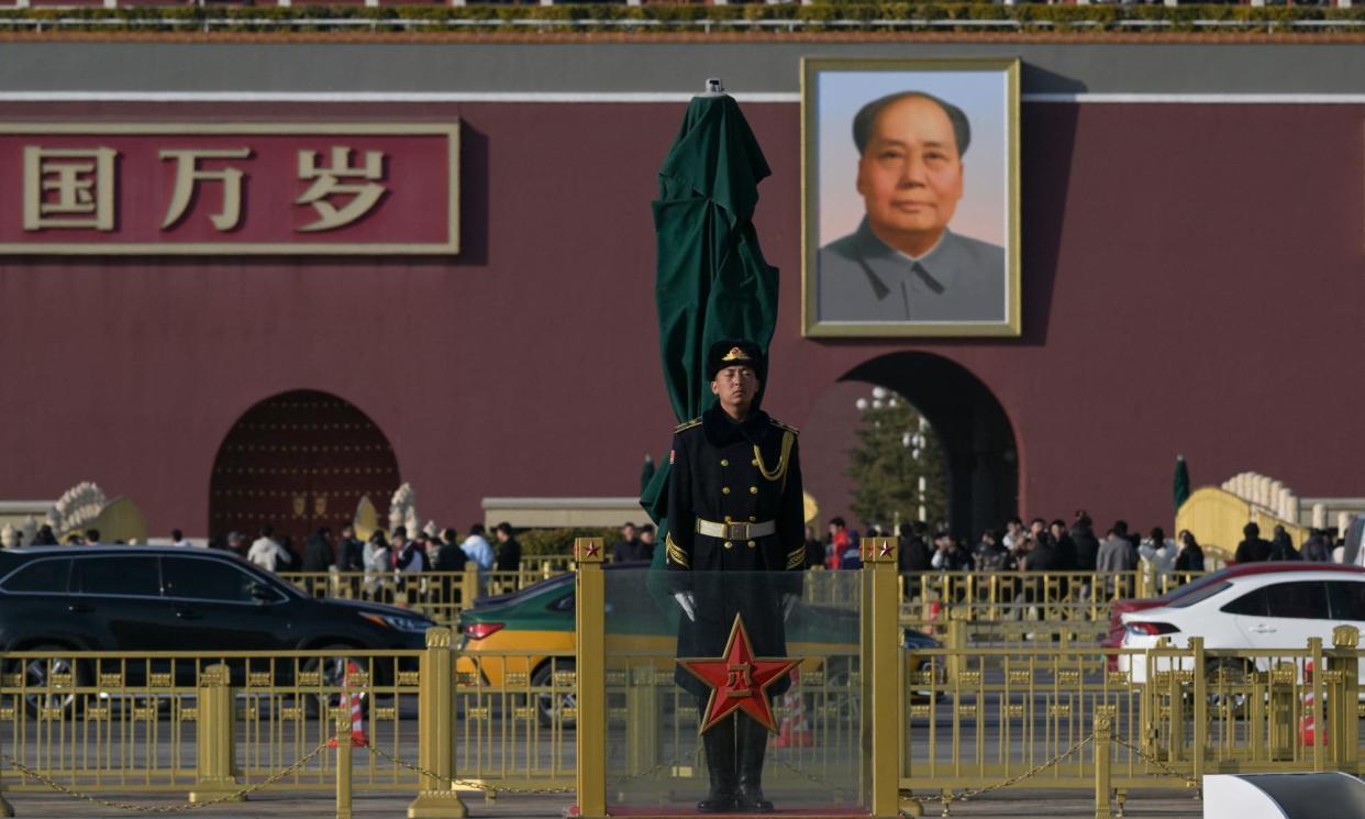 <span>A Chinese People’s Liberation Army soldier stands guard in front of a portrait of the late Communist leader Mao Zedong outside Tiananmen Gate in Beijing.</span><span>Photograph: Pedro Pardo/AFP/Getty Images</span>