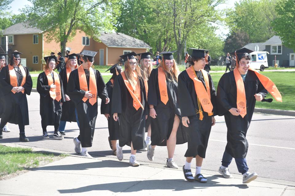 Seniors from Washington High School prepare to walk into their alma mater, Anne Sullivan Elementary School, to greet their youngest peers and say hello to their former teachers, on Tuesday, May 16, 2023.