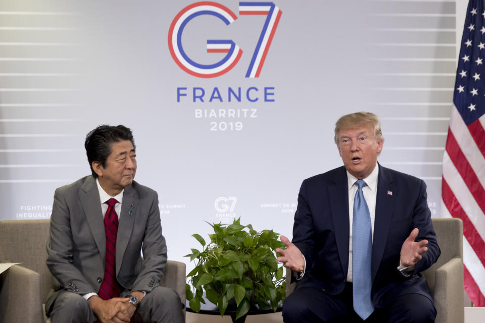 FILE - In this Aug. 25, 2019, file photo, U.S President Donald Trump and Japanese Prime Minister Shinzo Abe speak during a bilateral meeting at the G-7 summit in Biarritz, France to announce that the U.S. and Japan have agreed in principle on a new trade agreement. On Tuesday, Sept. 17, 2019, officials in Japan appear wary over the prospects for a trade deal with the U.S. after President Donald Trump said he was prepared to sign a pact soon. (AP Photo/Andrew Harnik, File)