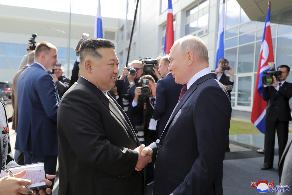 In this photo provided by the North Korean government, Russian President Vladimir Putin, right, welcomes North Korean leader Kim Jong Un at the Vostochny cosmodrome outside the city of Tsiolkovsky, about 200 kilometers (125 miles) from the city of Blagoveshchensk in the far eastern Amur region, Russia, Wednesday, Sept. 13, 2023. Independent journalists were not given access to cover the event depicted in this image distributed by the North Korean government. The content of this image is as provided and cannot be independently verified. Korean language watermark on image as provided by source reads: "KCNA" which is the abbreviation for Korean Central News Agency. (Korean Central News Agency/Korea News Service via AP)