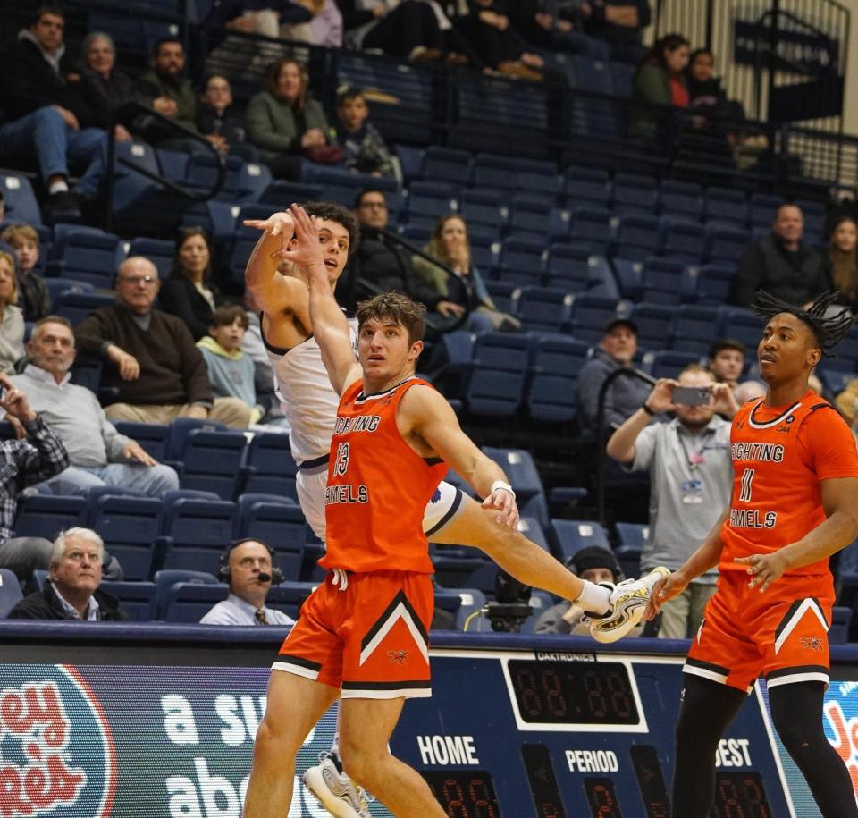 Monmouth's Xander Rice launches the game-winning 3-pointer, falling to the ground as time expired to lift his team to an 88-87 win over Campbell on Feb. 15, 2024 in West Long Branch, N.J.