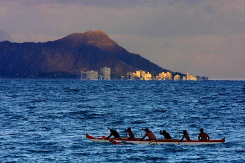 An outrigger canoe is seen off the shore of Waikiki Beach in Honolulu, Hawaii.