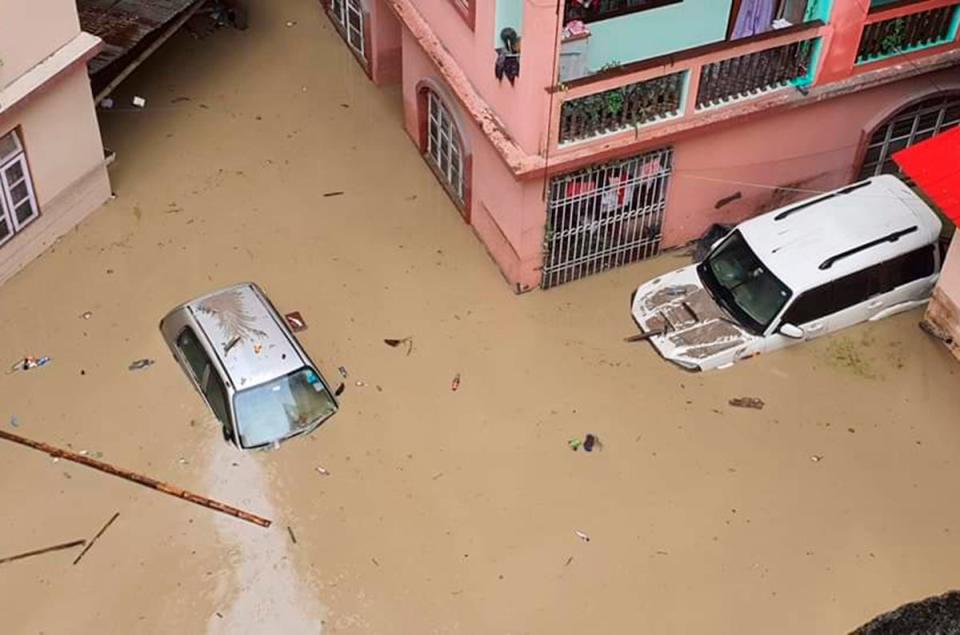 Cars lie submerged in water after flash floods triggered by a sudden heavy rainfall swamped the Rangpo town in Sikkim, India (AP)